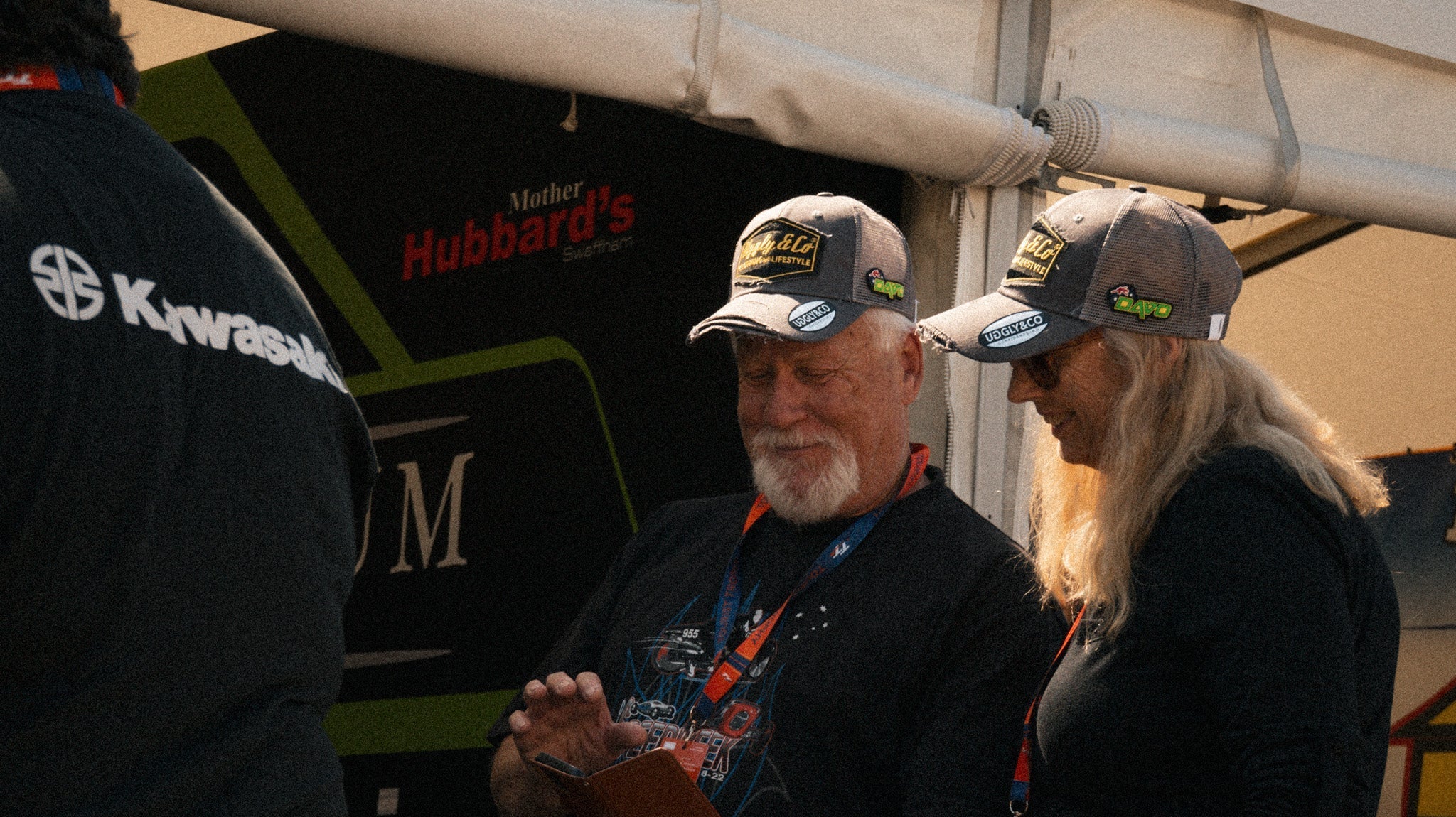 two tt fans in the paddock wearing davo Johnson trucker hats