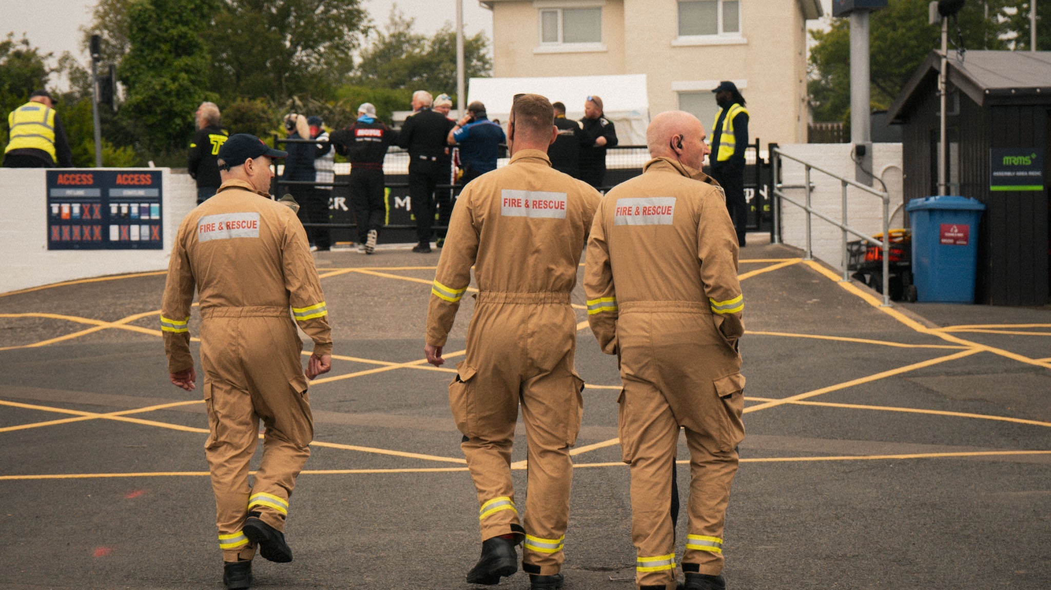 fire men in pit lane at race track