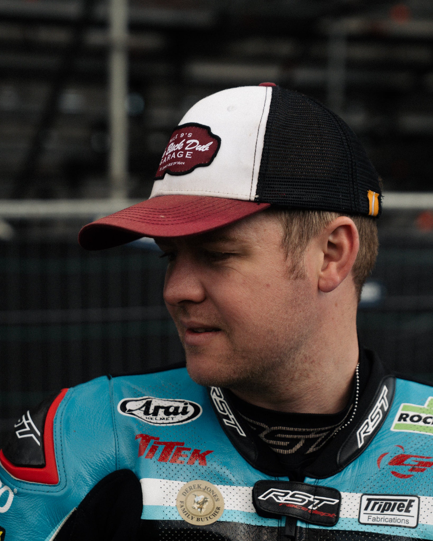 Dan Ingham in black dub hat by race stands side profile