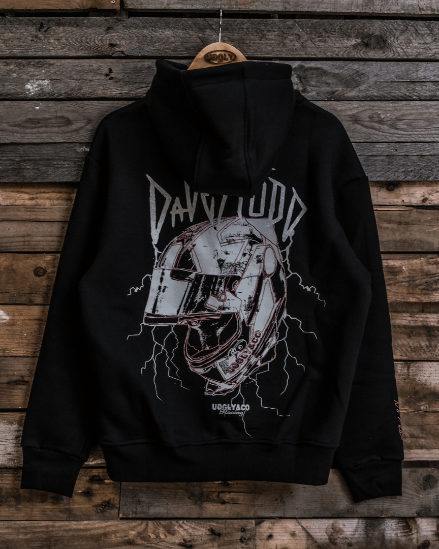 Black hoodie with graphic design on a wooden background