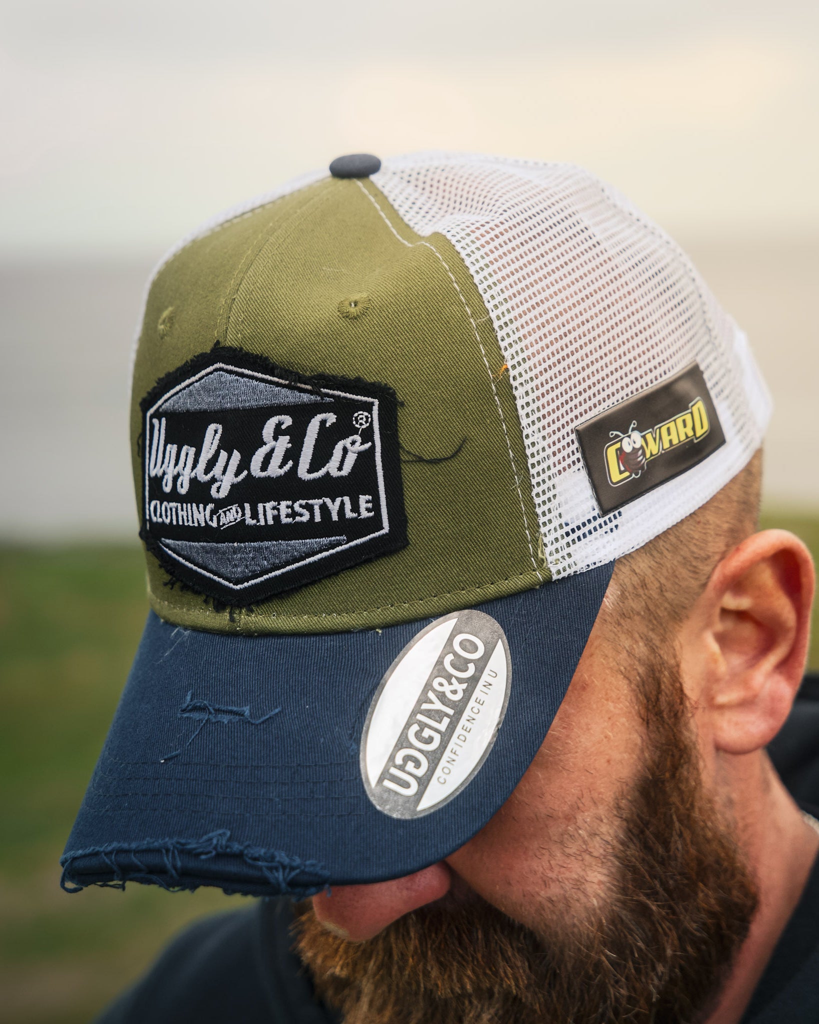 Jamie Coward in green and navy trucker hat