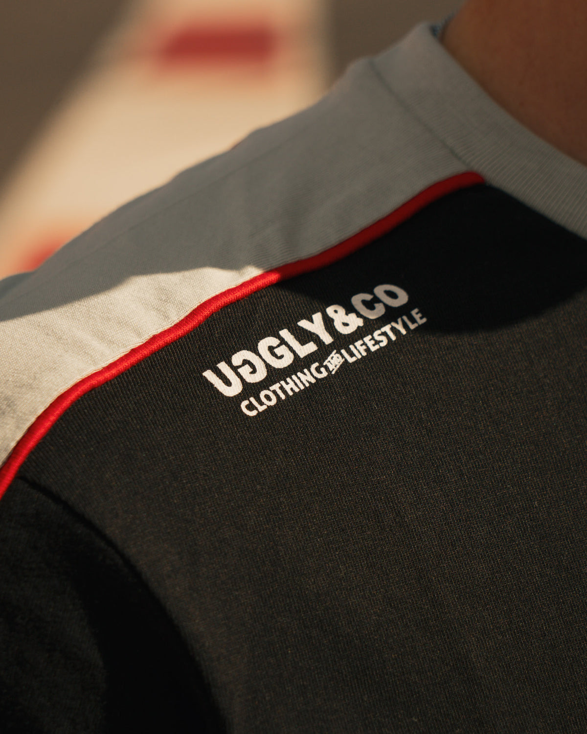close up shot of uggly and co logo on biota tshirt