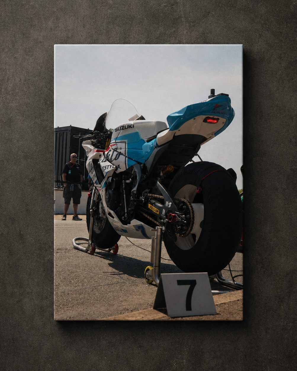 Low angle rear view of Josh Brookes’ Uggly & Co Isle of Man TT race bike in the paddock, displayed as canvas wall art.