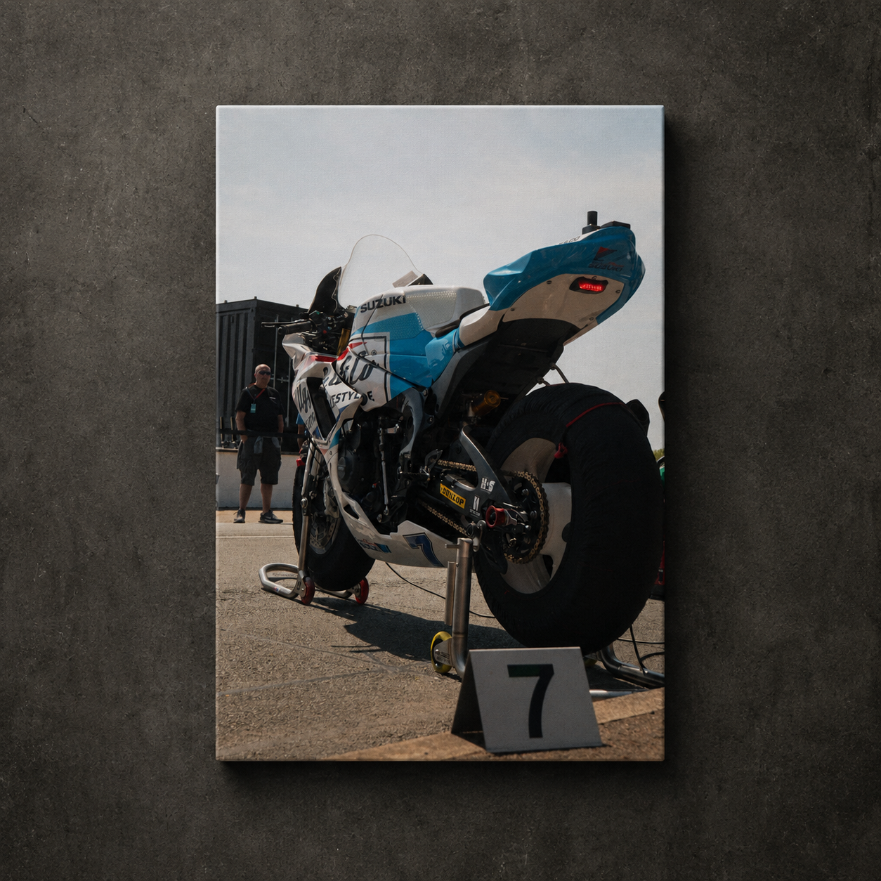 Low angle rear view of Josh Brookes’ Uggly & Co Isle of Man TT race bike in the paddock, displayed as canvas wall art.