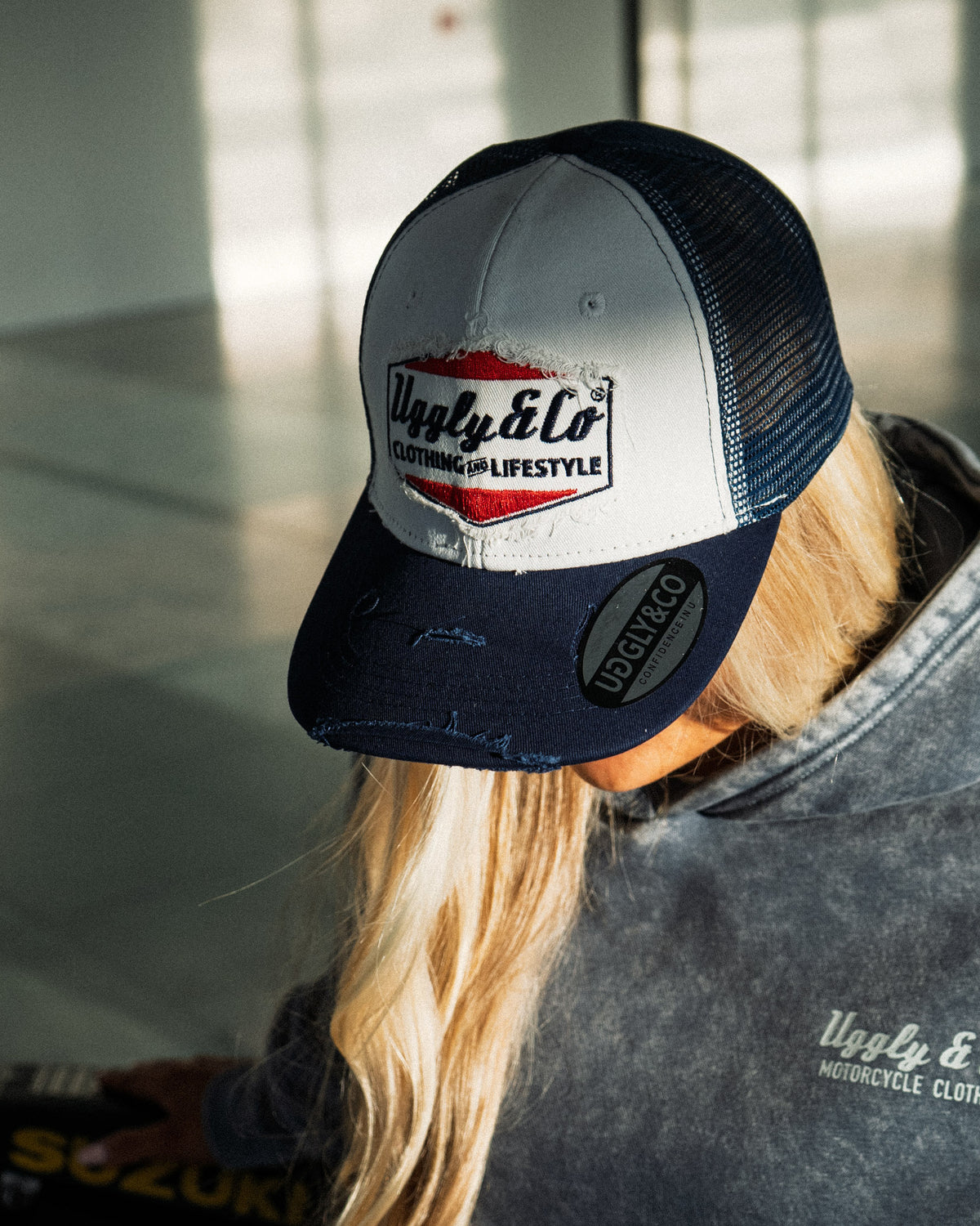 Abby Marshall in the Uggly & Co Navy Blue & White Diamond Trucker Hat