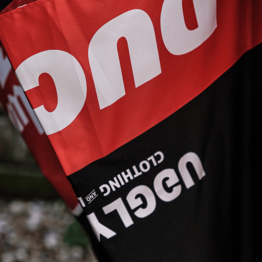 Close up of a red and black Milwaukee x Ducati umbrella with Milwaukee logo