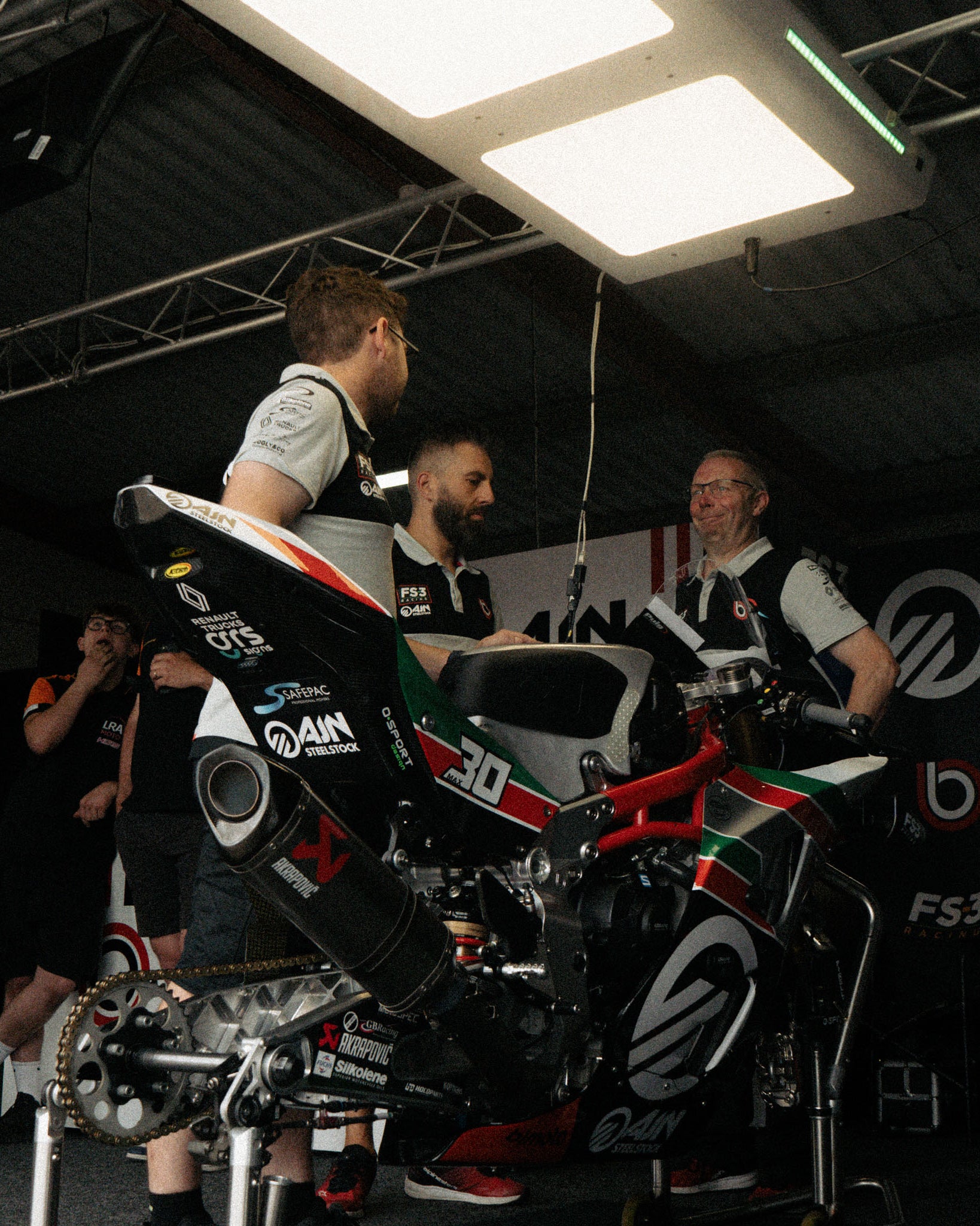 Bimota FS-3 team wearing British Superbikes Polo Shirts inside the race garage.