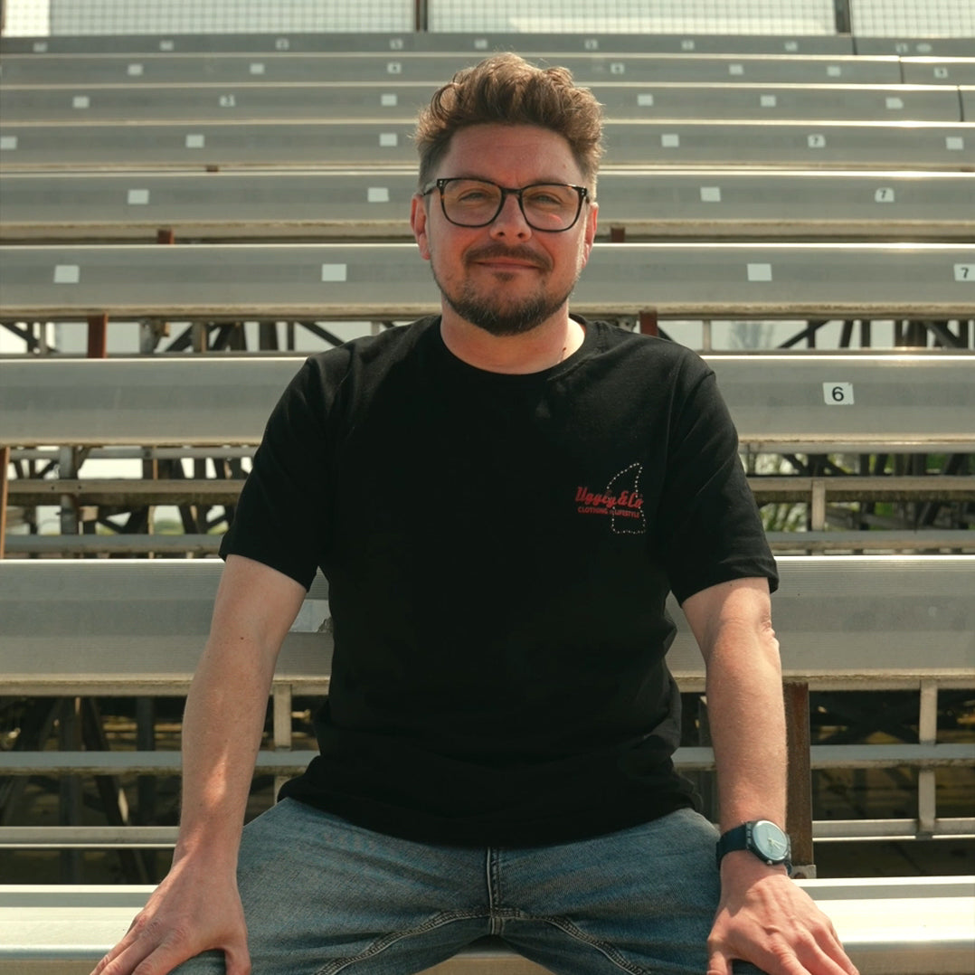 Lifestyle photo of Steve Day in the black Uggly&Co ‘The Map’ tee at the track