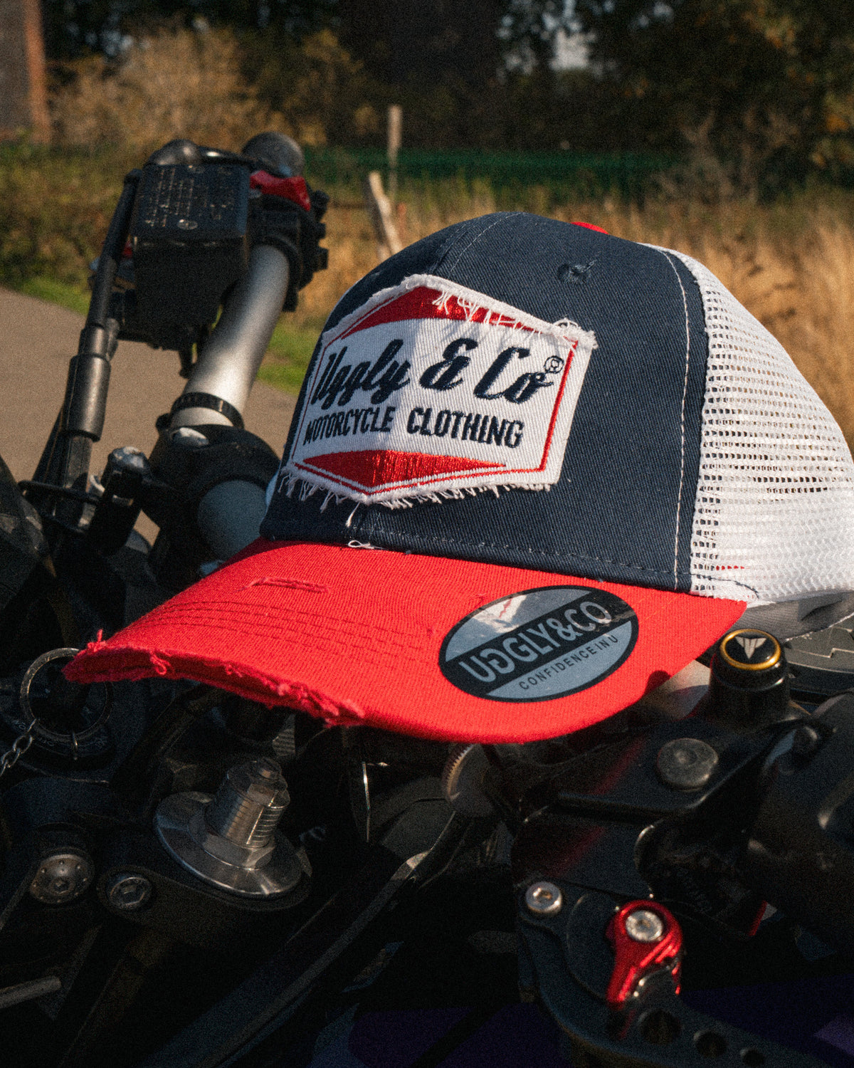 Blue and Red Diamond Trucker Hat styled in a motorcycle lifestyle setting