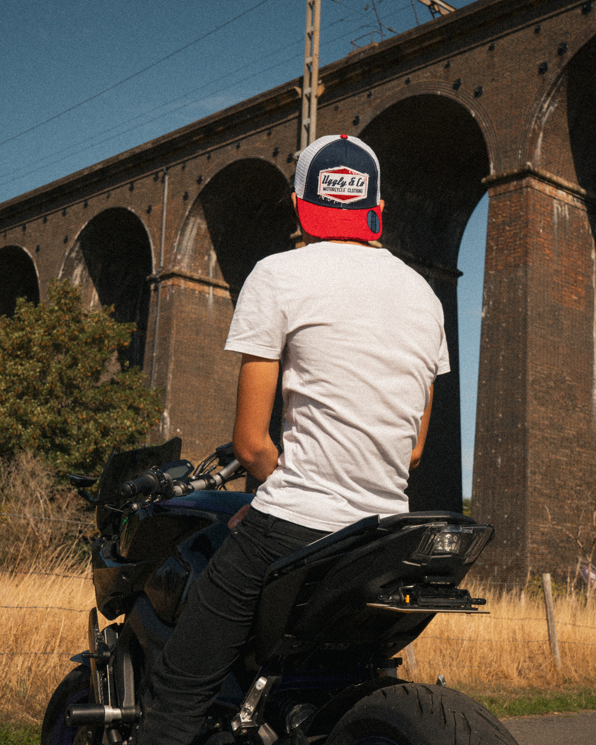 Lifestyle photo of a rider wearing the Blue and Red Diamond Trucker Hat