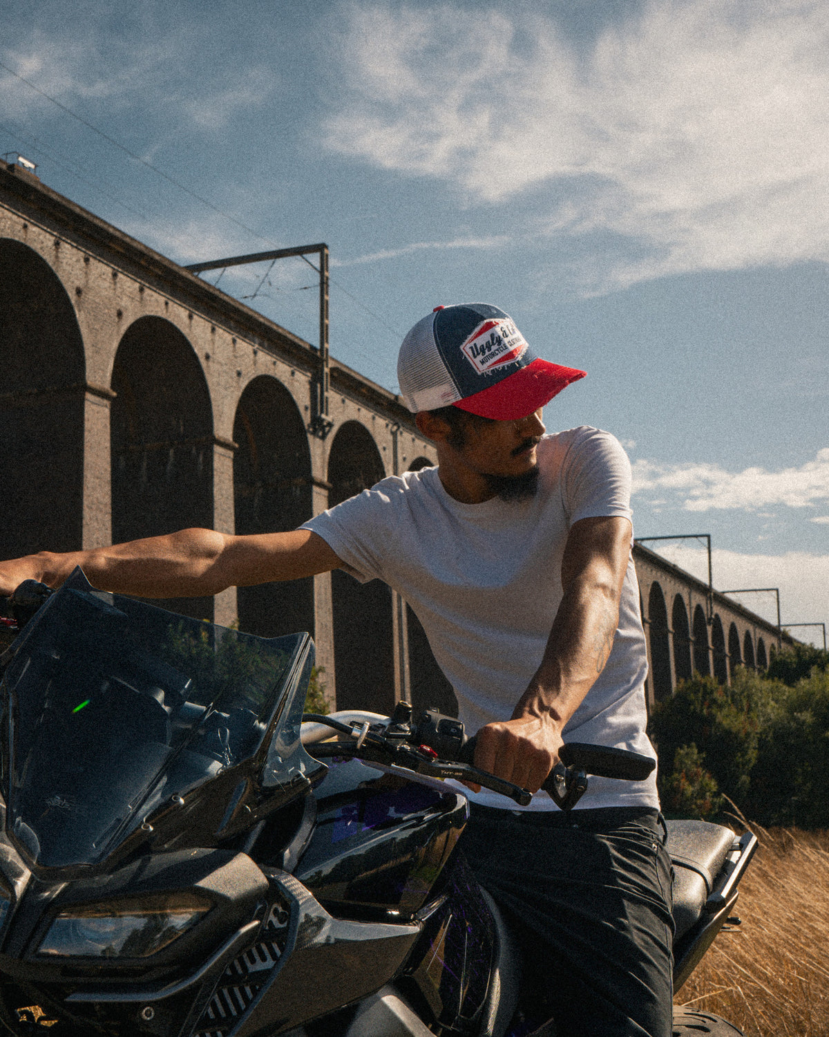 Lifestyle photo of a rider wearing the Blue and Red Diamond Trucker Hat