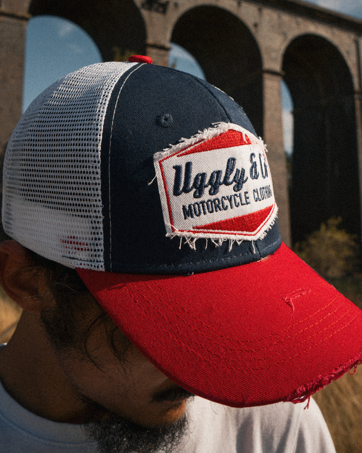 Close up of a motorcycle rider wearing the Blue and Red Diamond Trucker Hat