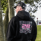 Brad Ray, BSB Racer wearing a black hoodie with a pink and white design on the back, standing outdoors.