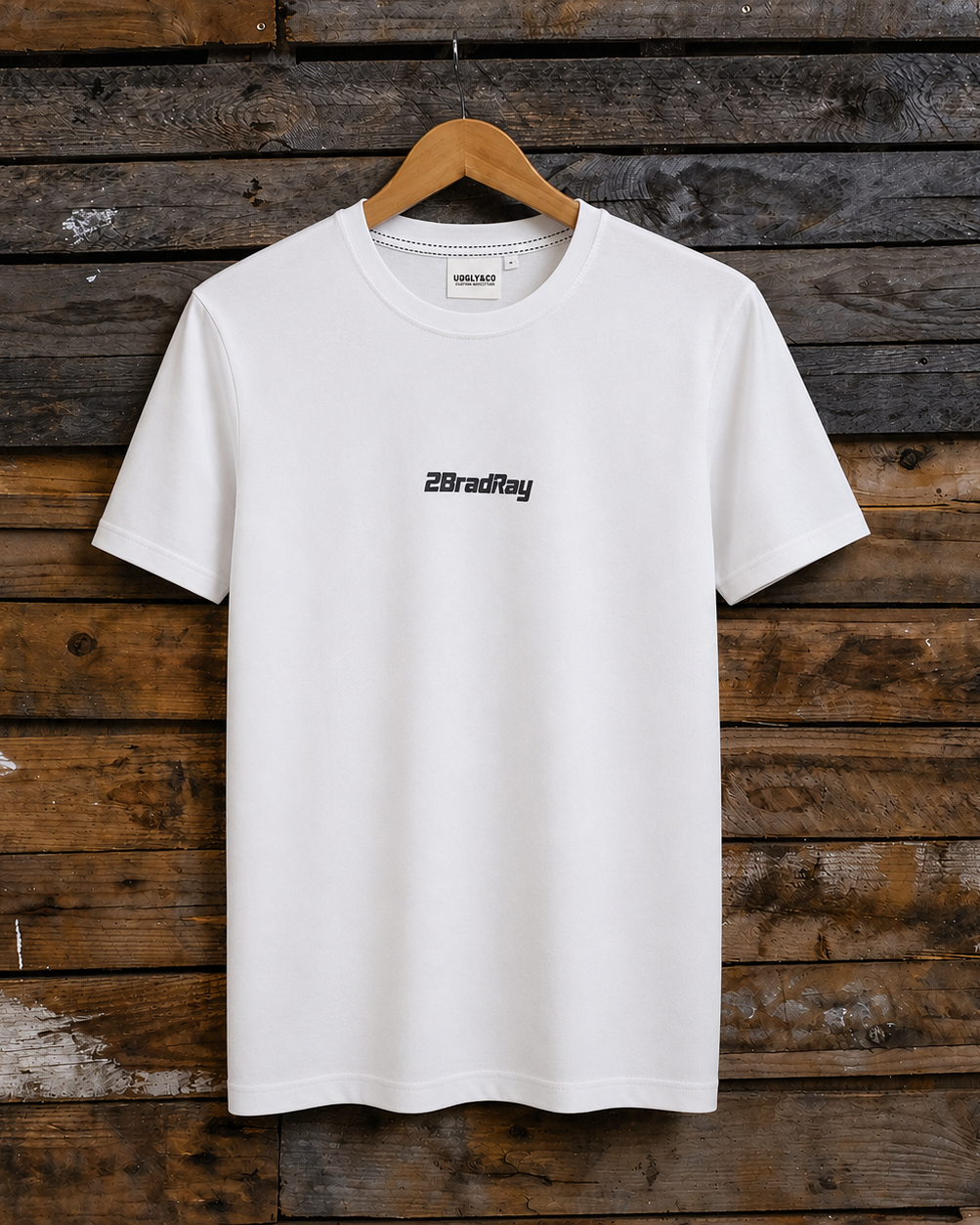 Front view of a Bradley Ray signature take the risk white t-shirt on a wooden background