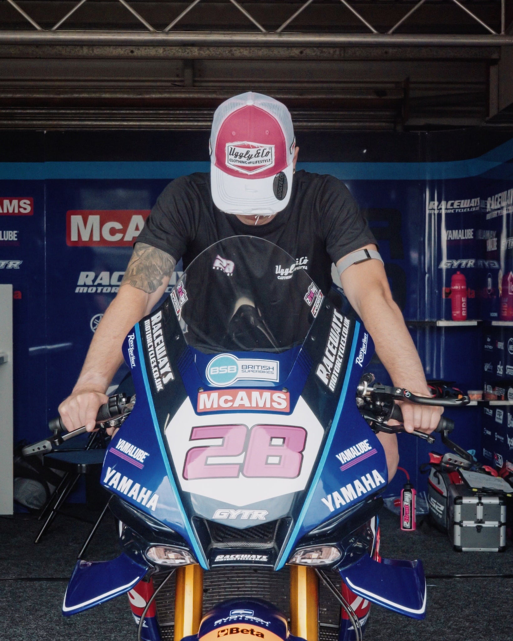 pink and white Bradley Ray 28 Diamond trucker hat in garage