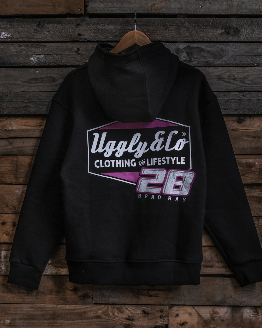 Black hoodie with a Uggly&Co and Bradley Ray 28 brand logo on a wooden background