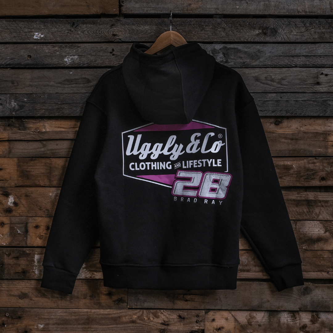 Black hoodie with a Uggly&Co and Bradley Ray 28 brand logo on a wooden background