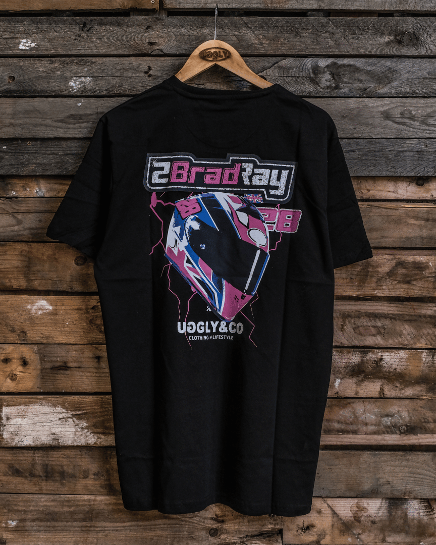 Black t-shirt with graphic design and text on a wooden background
