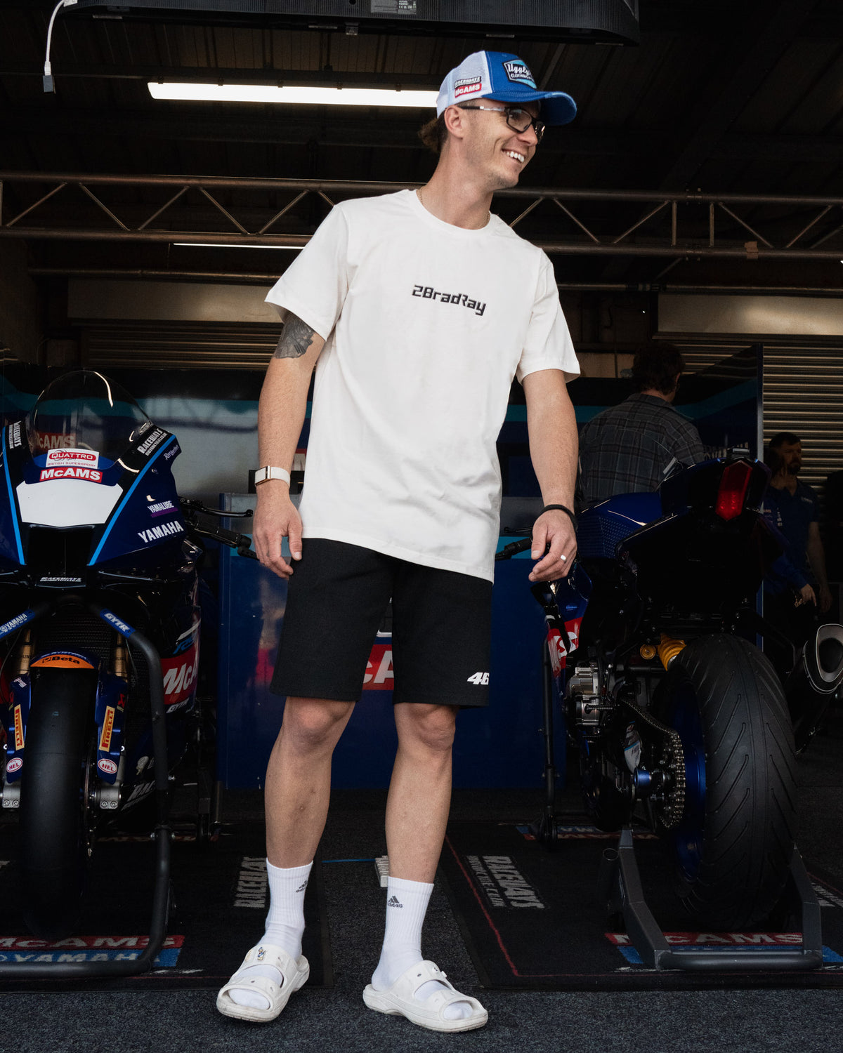 White Bradley Ray 'Take the Risk' T-Shirt in a motorcycle garage