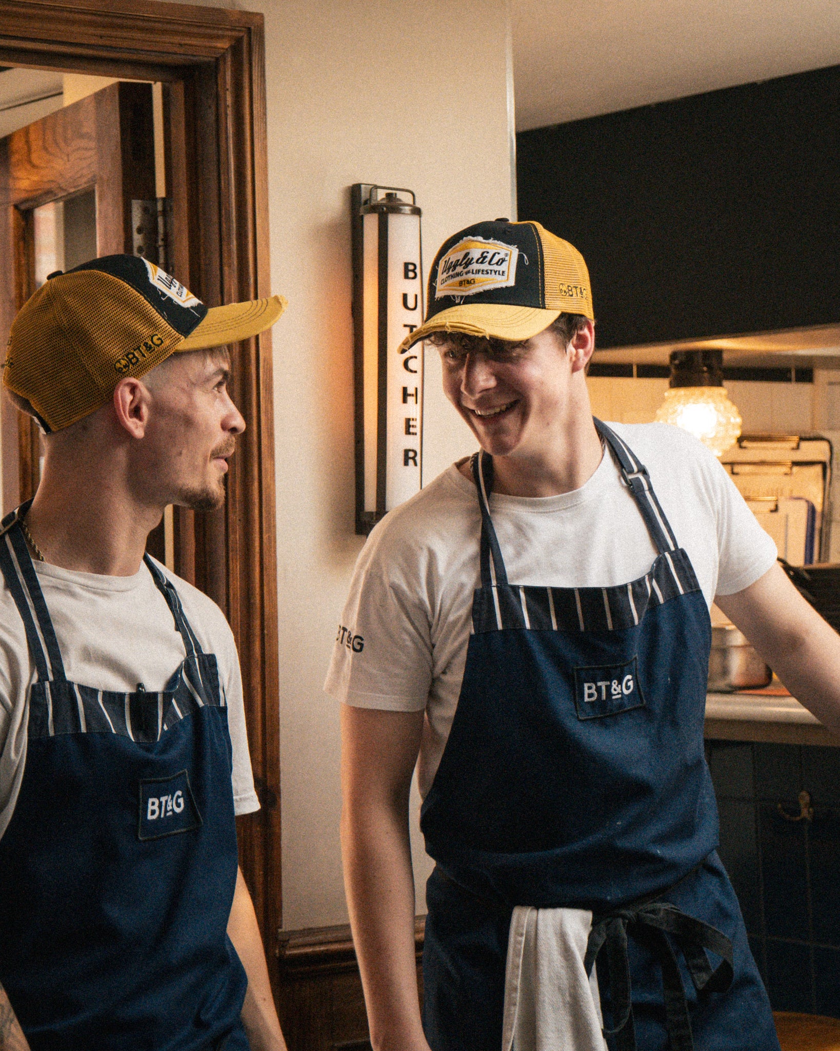 Butchers Tap chefs wearing matching branded caps in the restaurant kitchen.