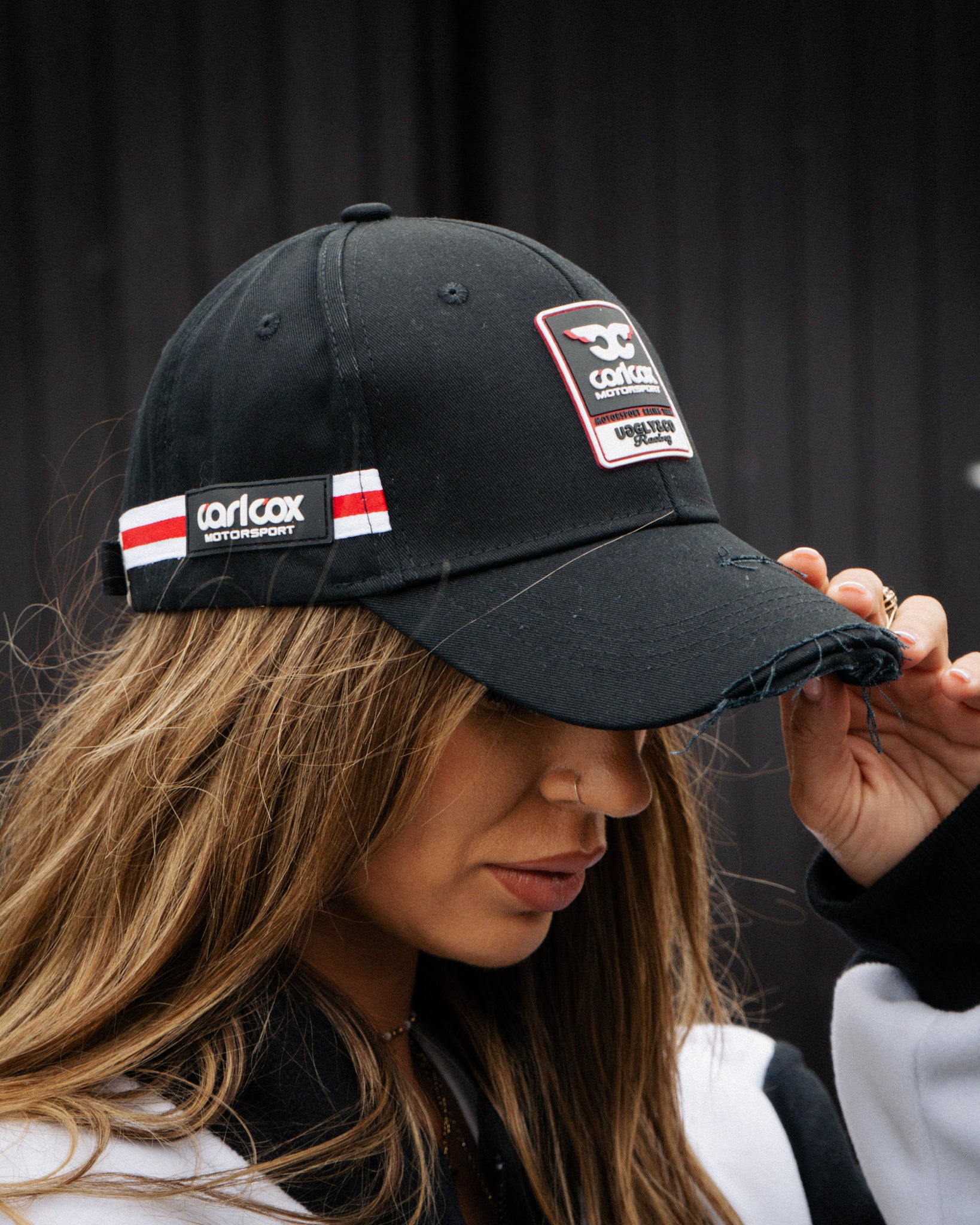 girl wearing carl cox motorsport jacket and cap