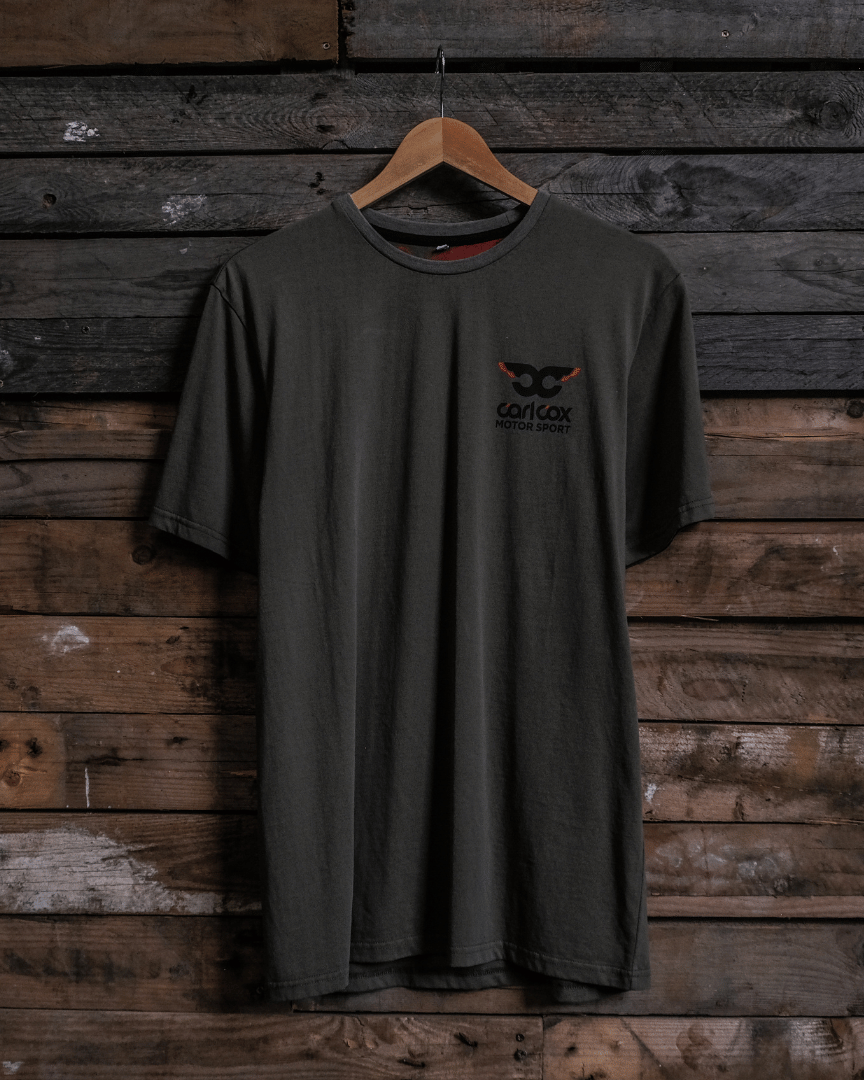 Front view of a Carl Cox Motorsport BPM RPM green t-shirt on a wooden background
