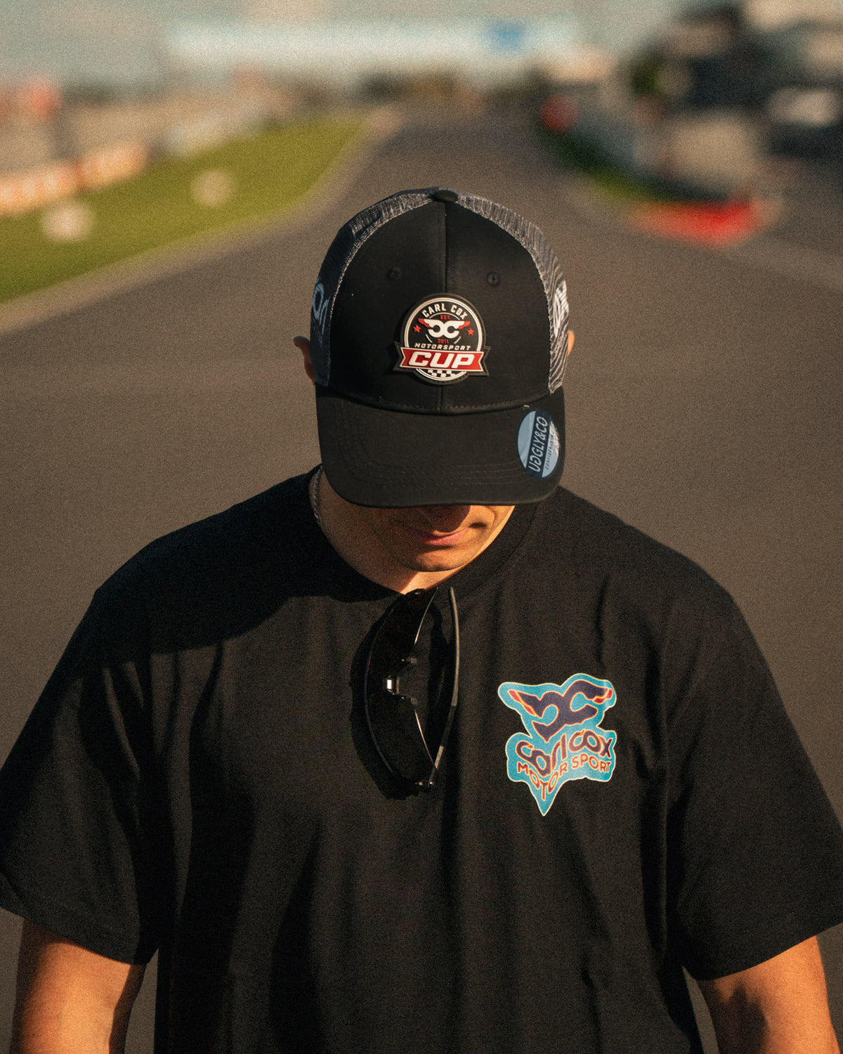 Front view of the Carl Cox Motorsport Cup Cap by Uggly & Co, featuring motorcycle racing inspired branding and classic motorsport headwear styling.
