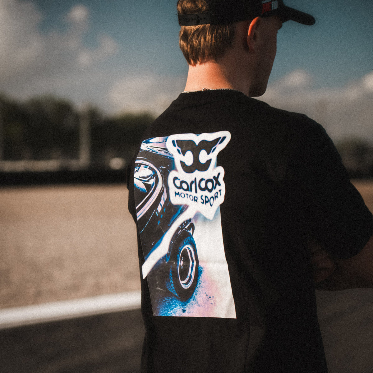 Back view of the Carl Cox Motorsport Mono Street Drive T-Shirt, showcasing motorcycle racing inspired streetwear from the Uggly & Co Carl Cox collection.