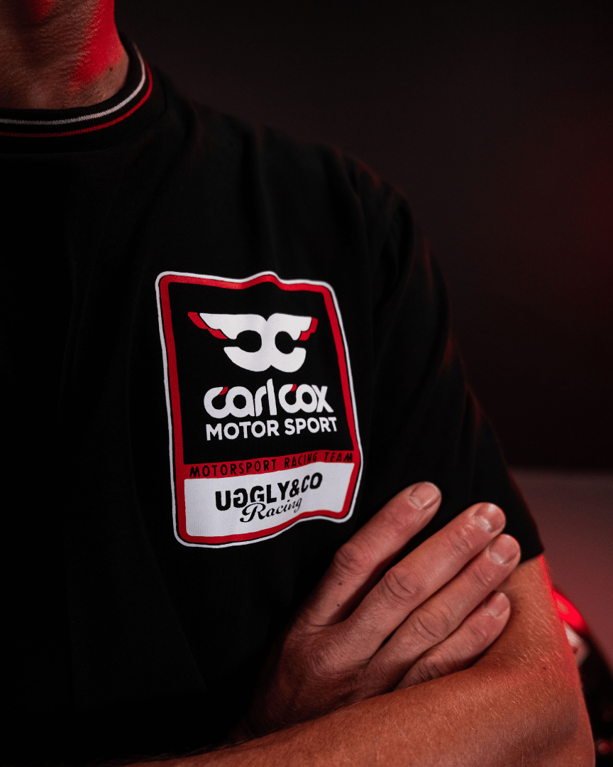 Close up of the chest logo on a Carl Cox motorsport black t-shirt with an Uggly&Co logo