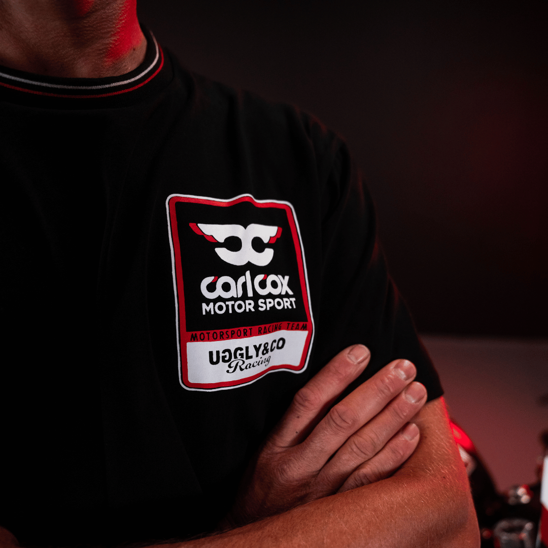 Close up of the chest logo on a Carl Cox motorsport black t-shirt with an Uggly&Co logo