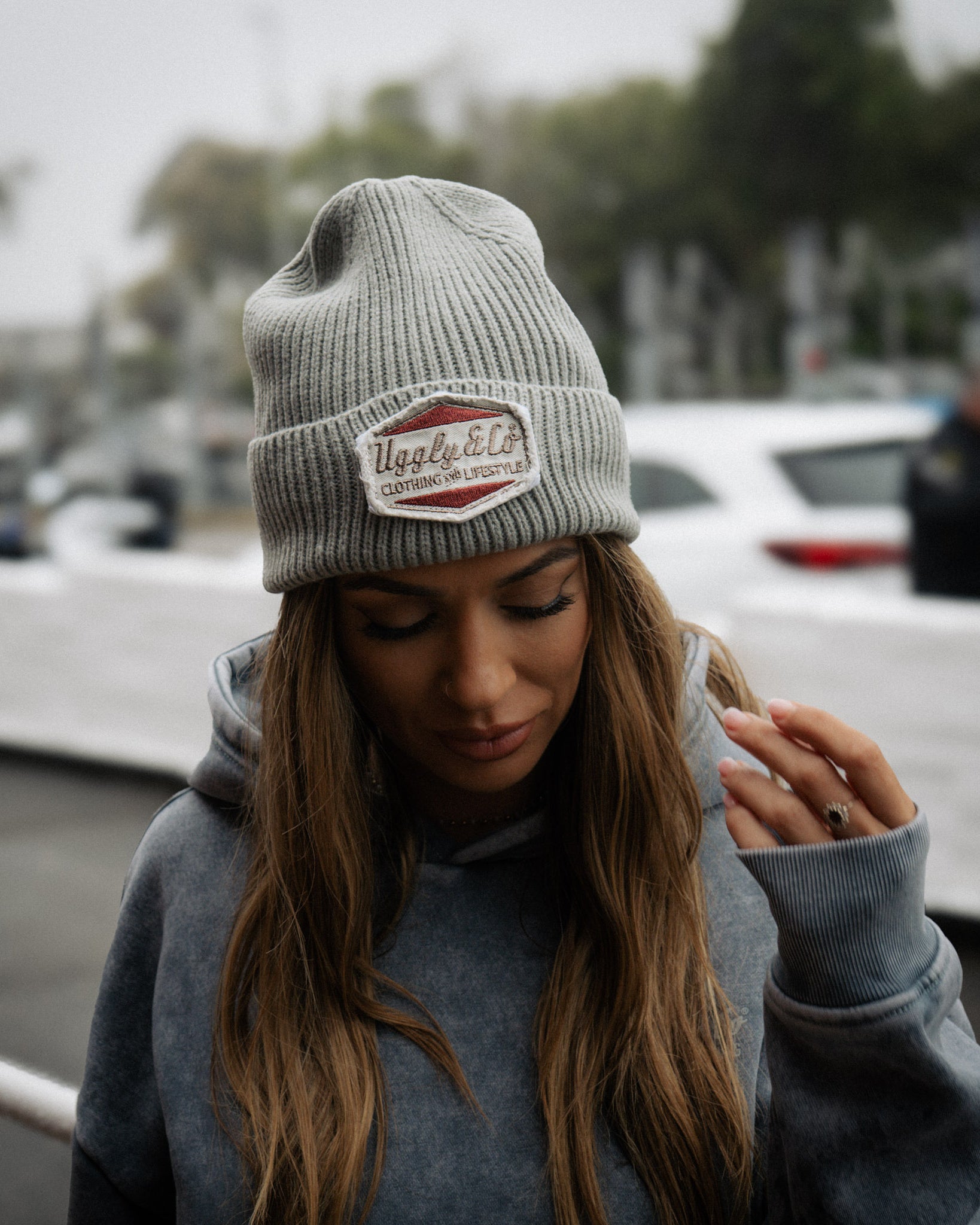 a close up shot of a girl wearing a blue acid wash vintage style hoodie