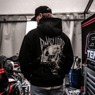 Davey Todd, Road Racer wearing a black hoodie with a graphic design in a garage setting