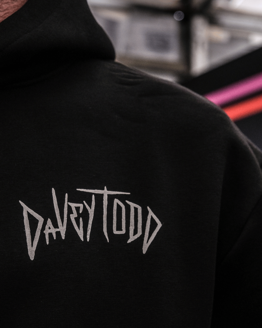 Black hoodie with 'DAVEYTOOD' logo on the back, blurred background