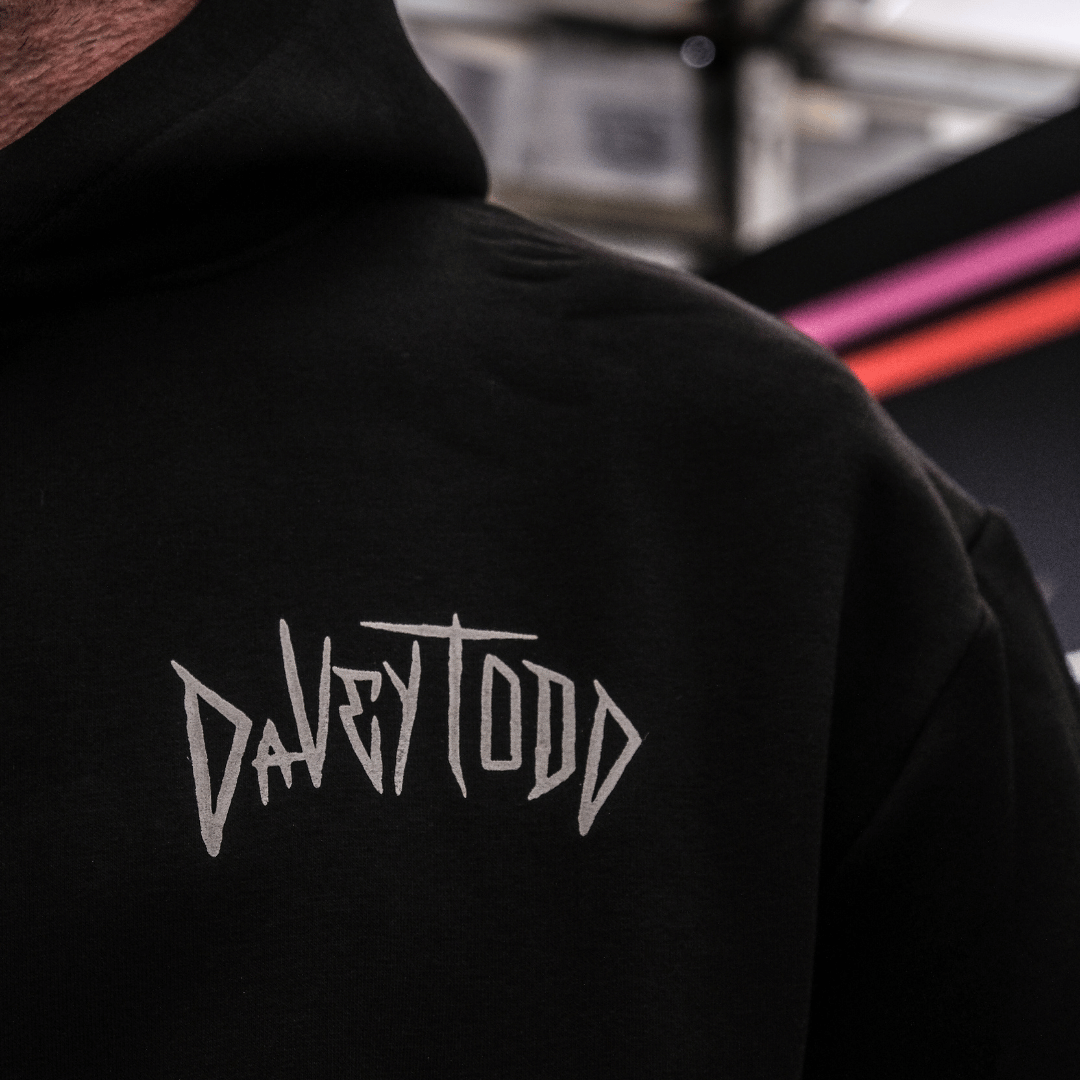 Black hoodie with 'DAVEYTOOD' logo on the back, blurred background