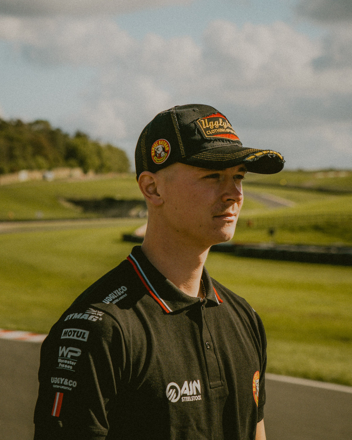 Side view of the Diamond Trucker Hat x Bathams Racing worn by storm stacey