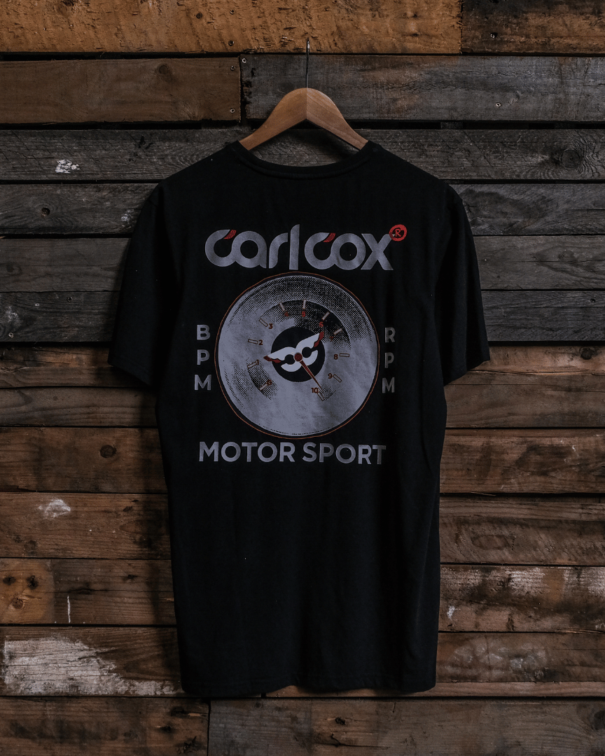 Rear view of a Carl Cox Motorsport BPM RPM black t-shirt on a wooden background
