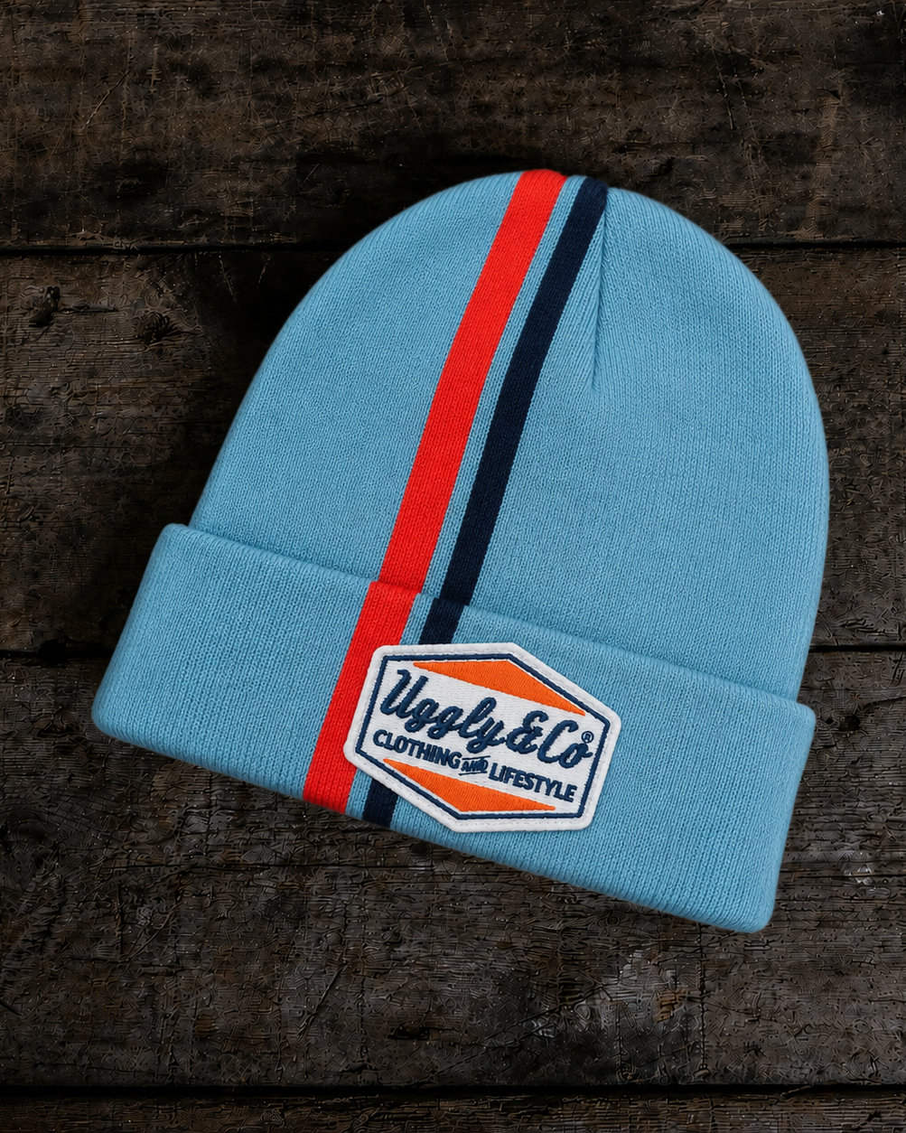 Front product photo of the Retro Diamond Light Blue & Orange Beanie on a wooden background