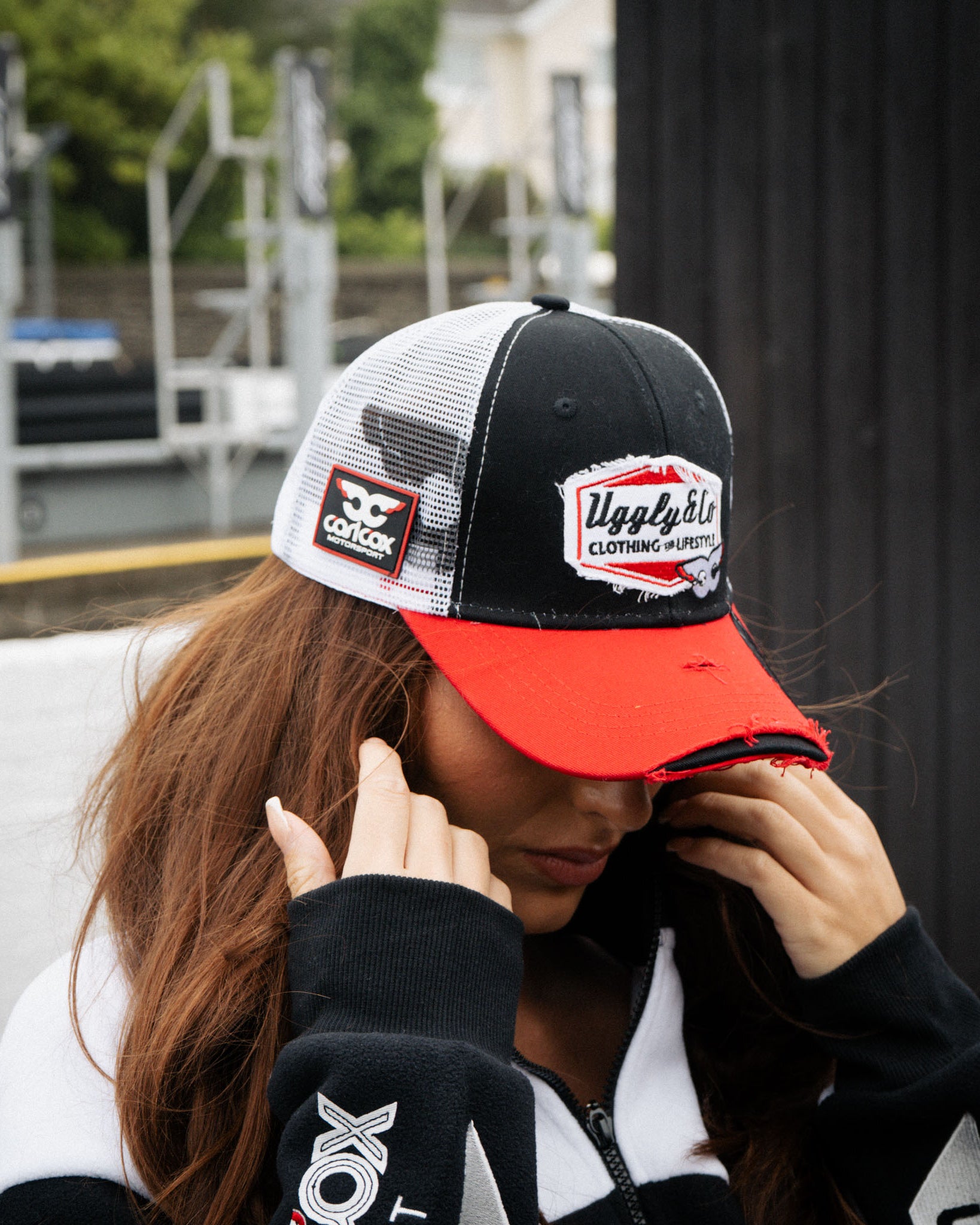 girl wearing matching carl cox trucker hat and track jacket