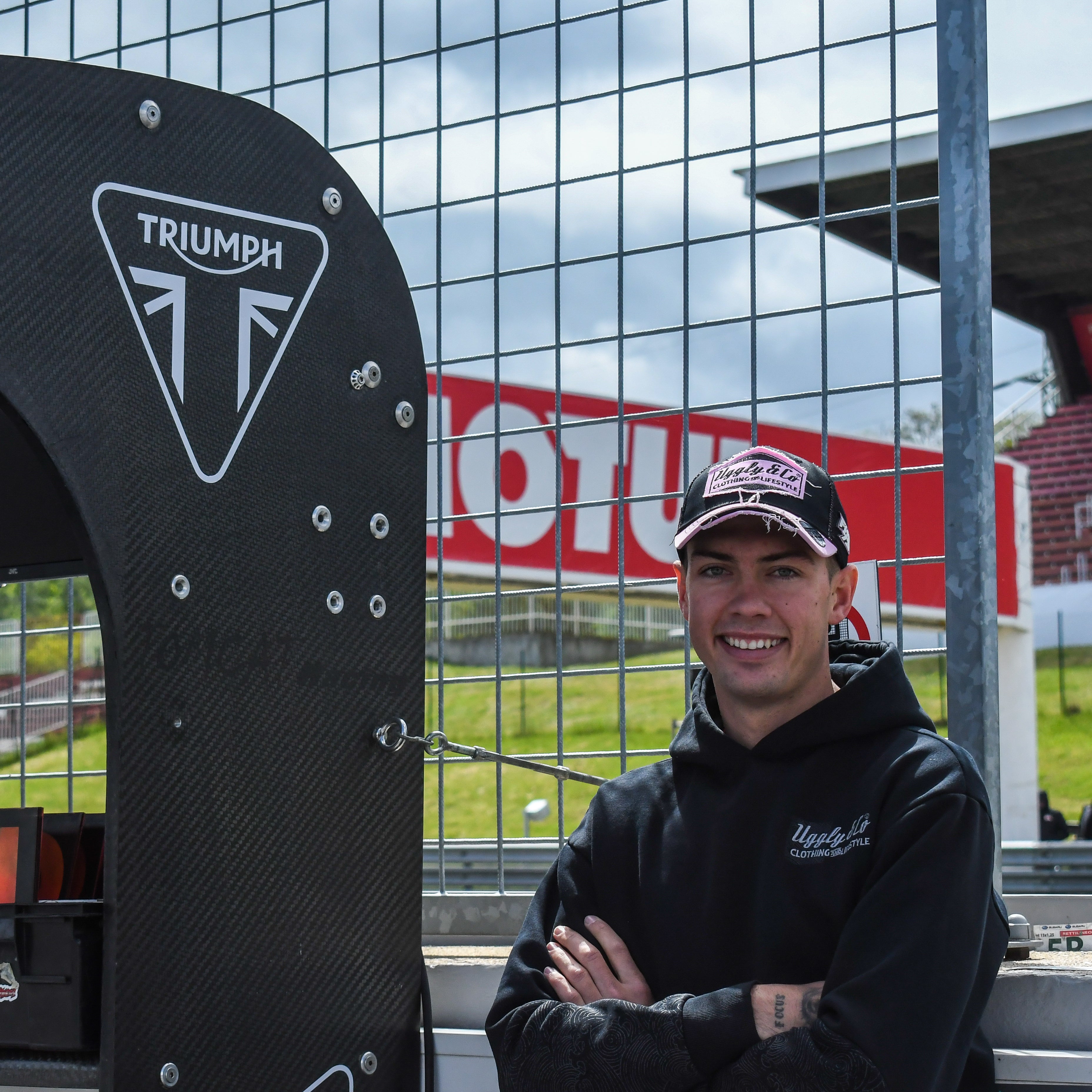 Trackside portrait of Fenton Seabright in a black and pink Diamond cap during a sunny race weekend