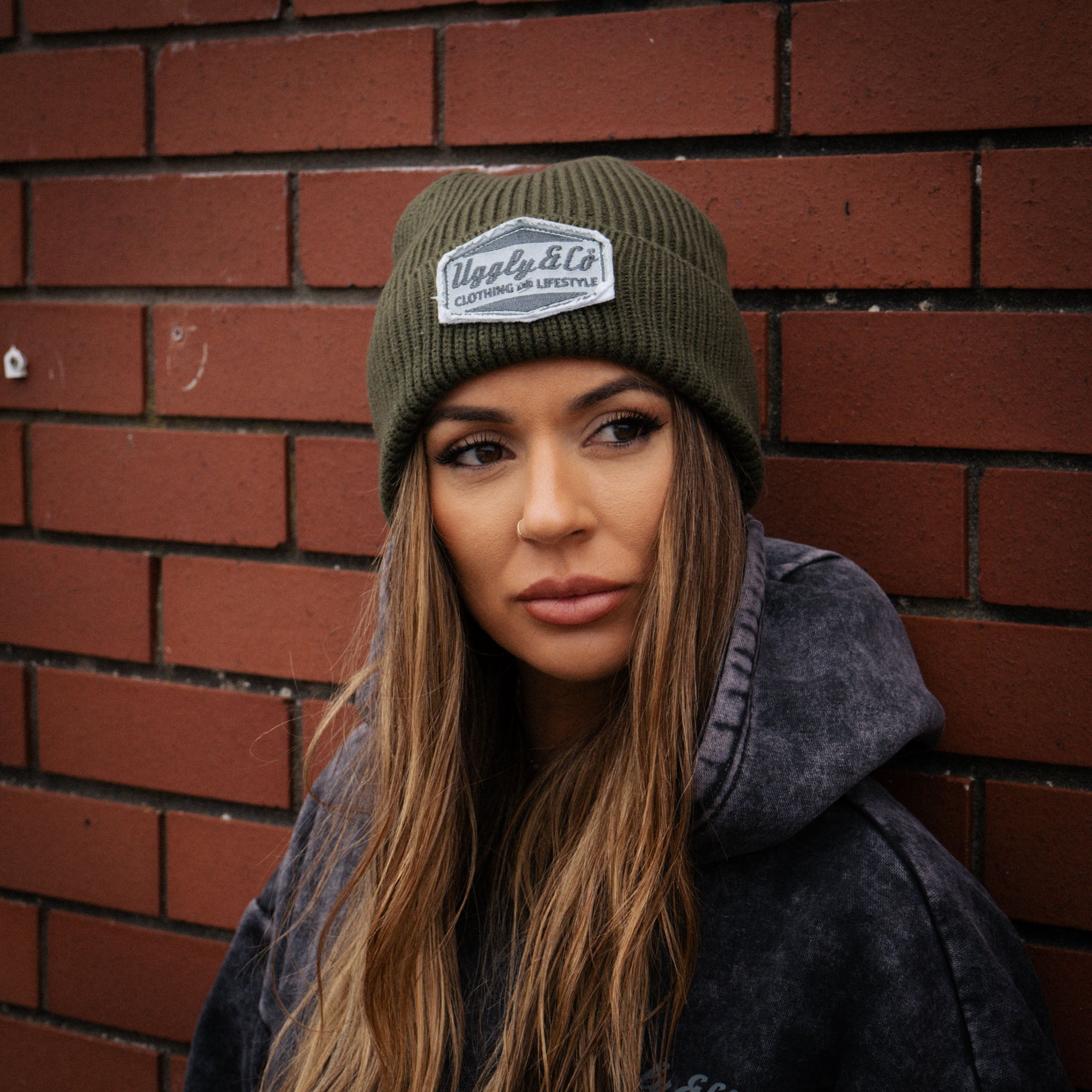 girl wearing a green beanie in an urban environment