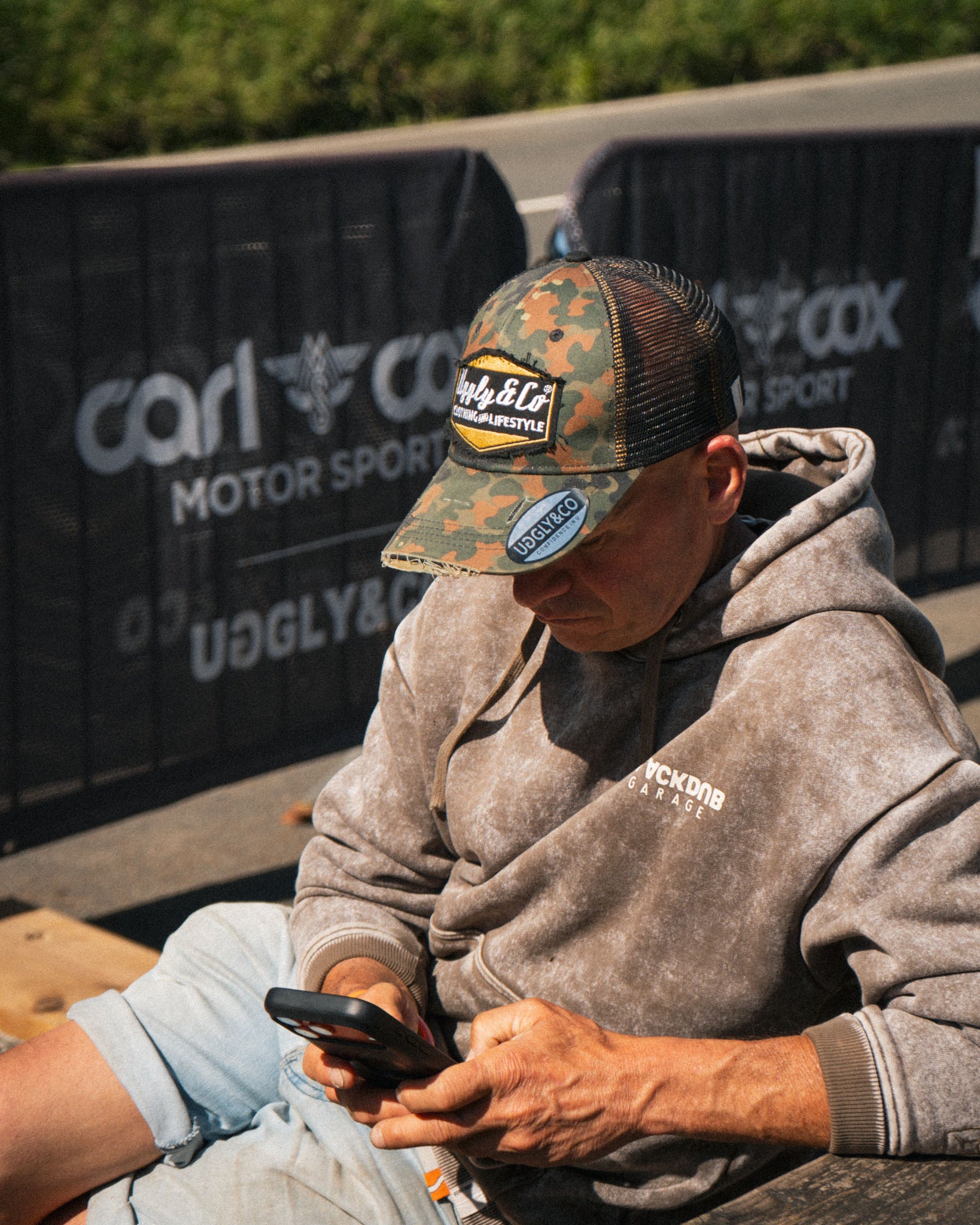 man at race event wearing camo hat