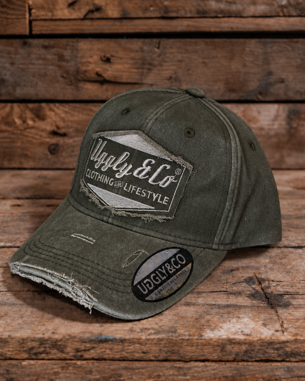 product photo showing green baseball cap with uggly and co diamond logo on a wood background