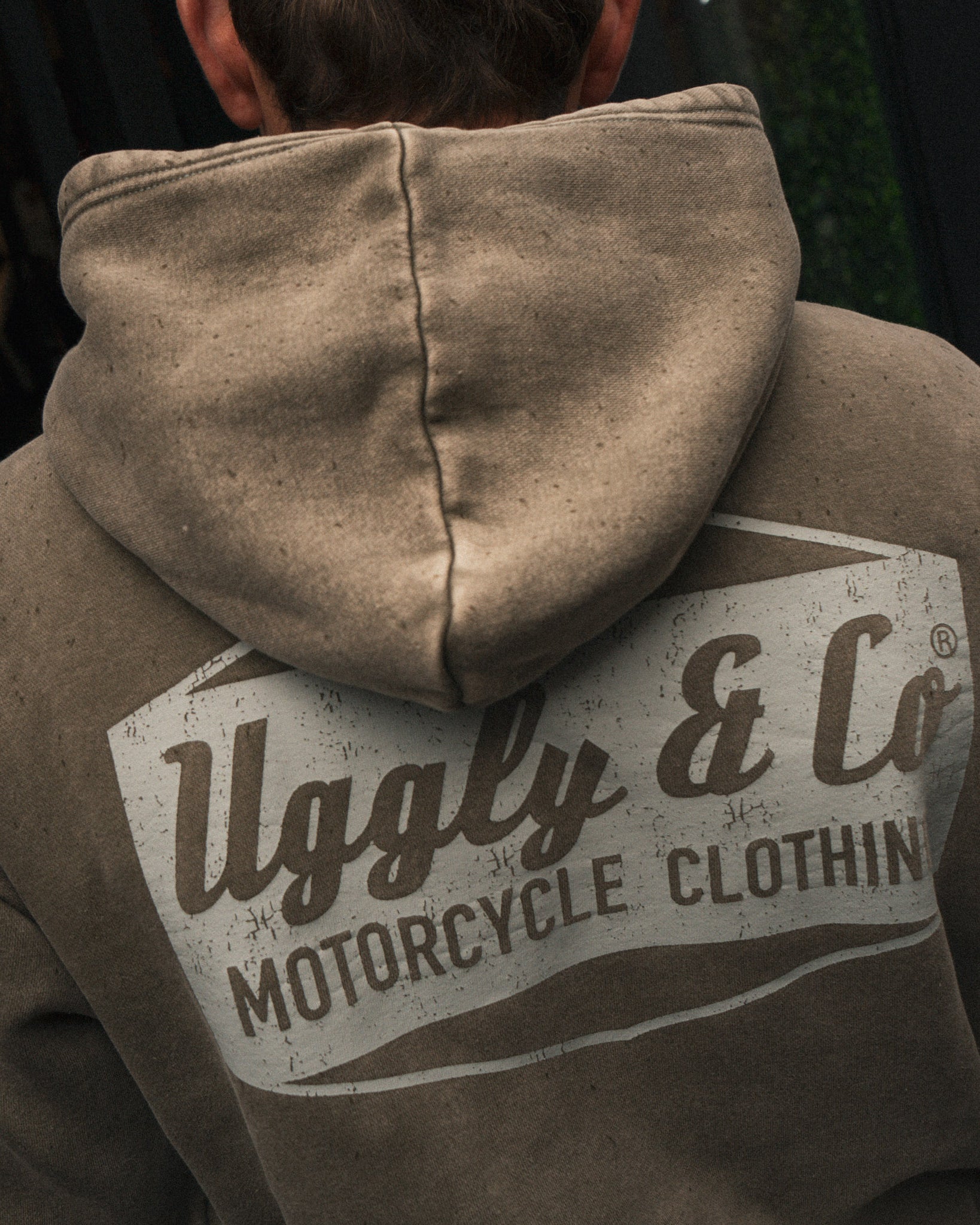 Close-up of Joey Thompson wearing the green Diamond acid wash hoodie, showing the hood and washed finish.