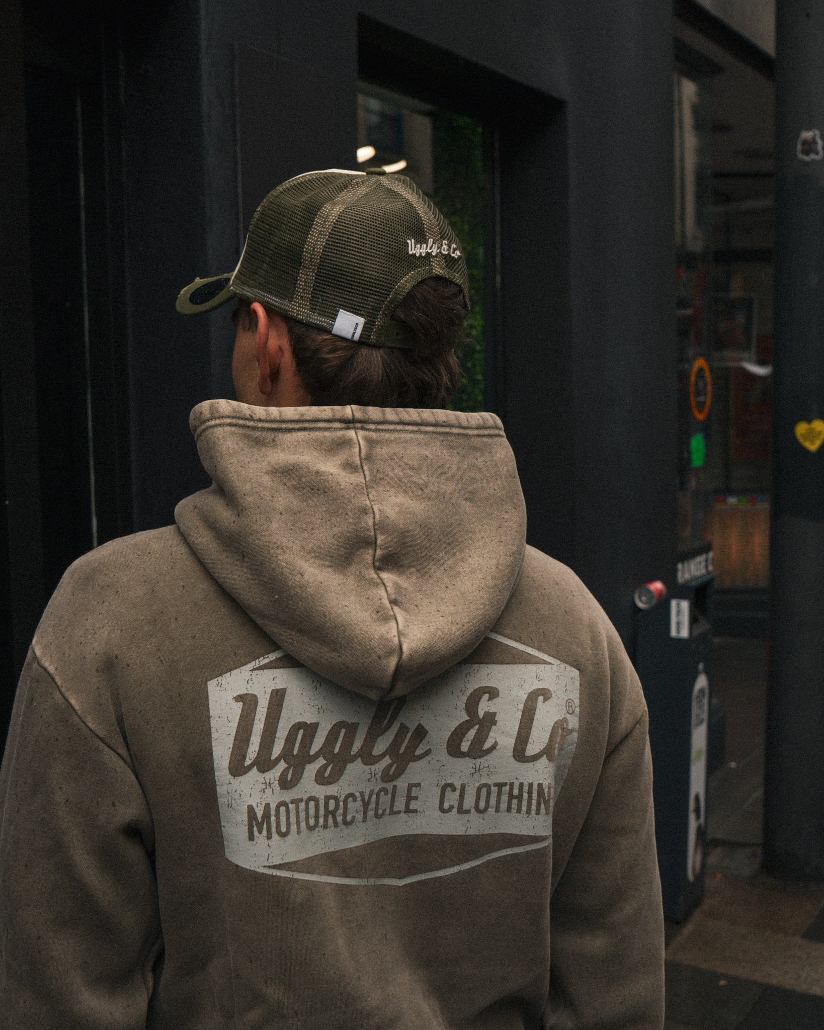 a photo of the back of a green acid wash hoodie worn by tt rider joey Thompson