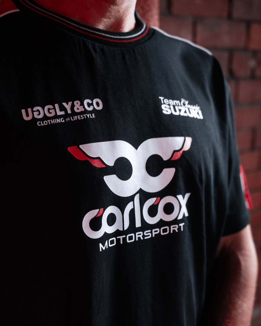Close up of Josh Brookes wearing a Carl Cox motorsport and Team Classic Suzuki black and red t-shirt