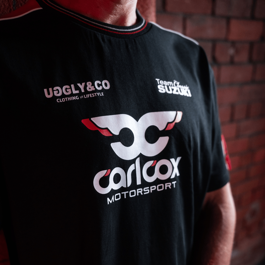 Close up of Josh Brookes wearing a Carl Cox motorsport and Team Classic Suzuki black and red t-shirt