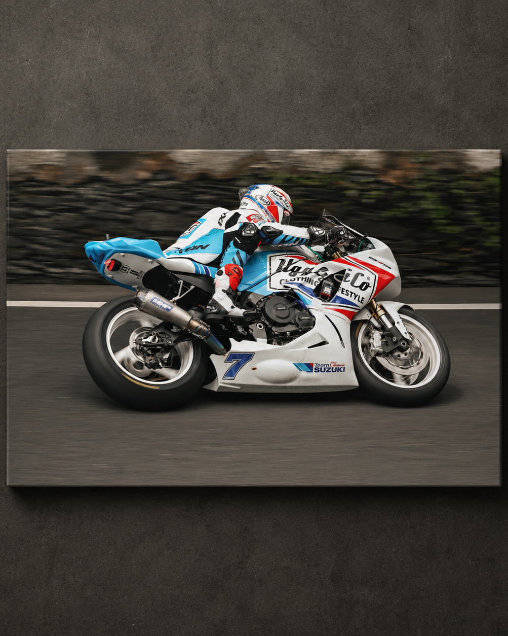 Side view panning shot of Josh Brookes riding the Uggly & Co TT bike during the Isle of Man TT, shown as canvas wall art.