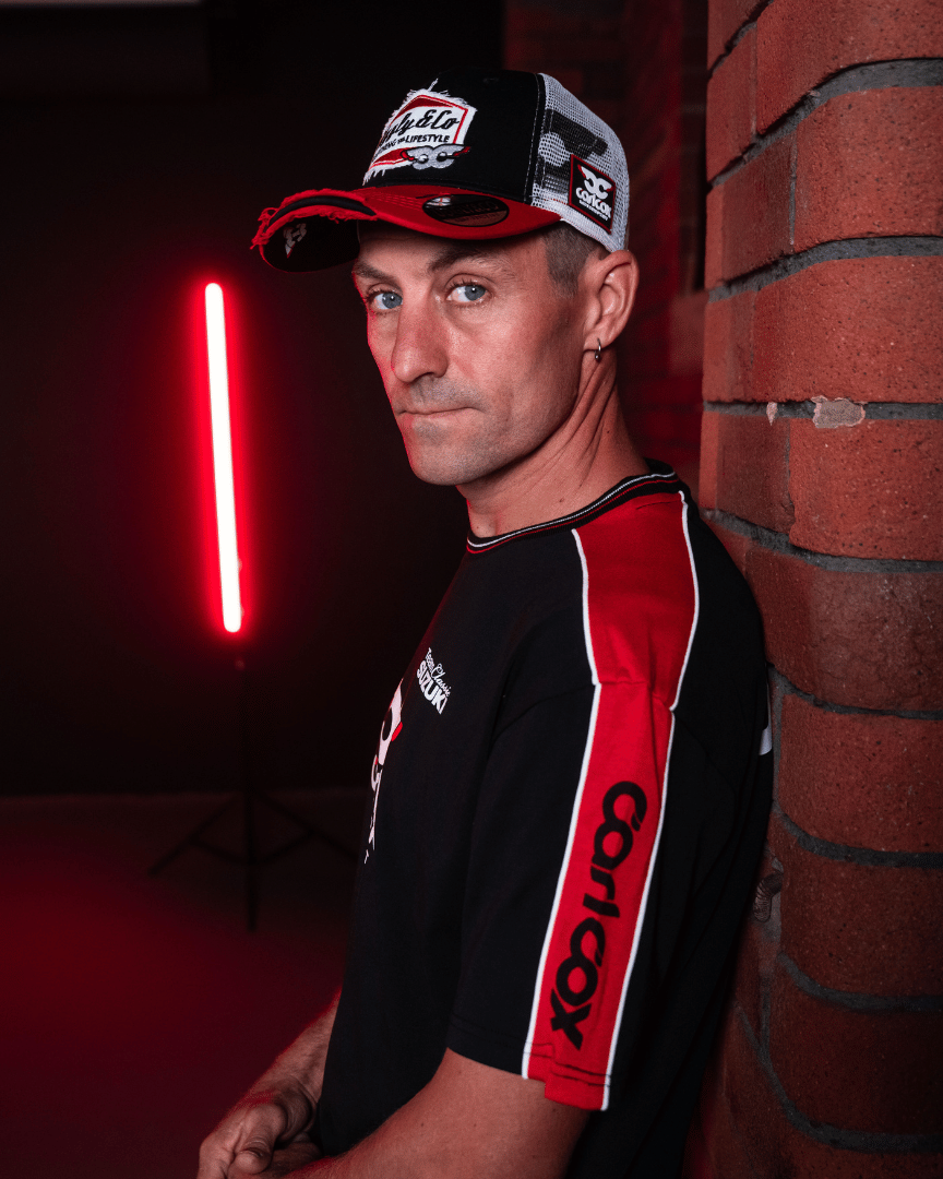 Josh Brookes wearing a Carl Cox motorsport and Team Classic Suzuki black and red t-shirt