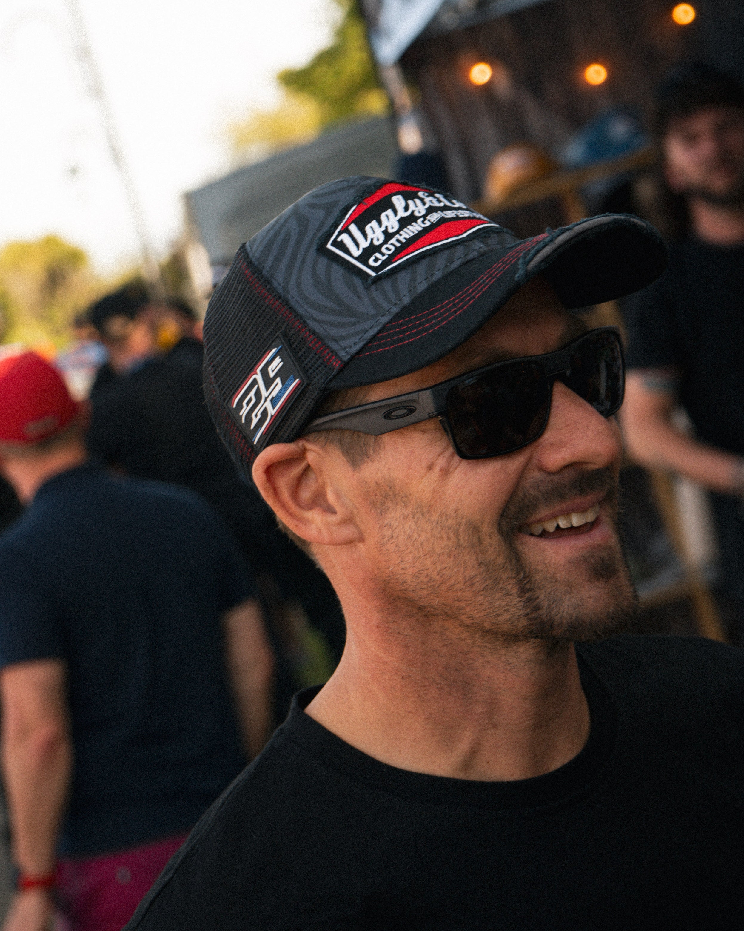 Lifestyle image of Josh Brooks wearing the zebra print Diamond Cap with a bold racewear look.