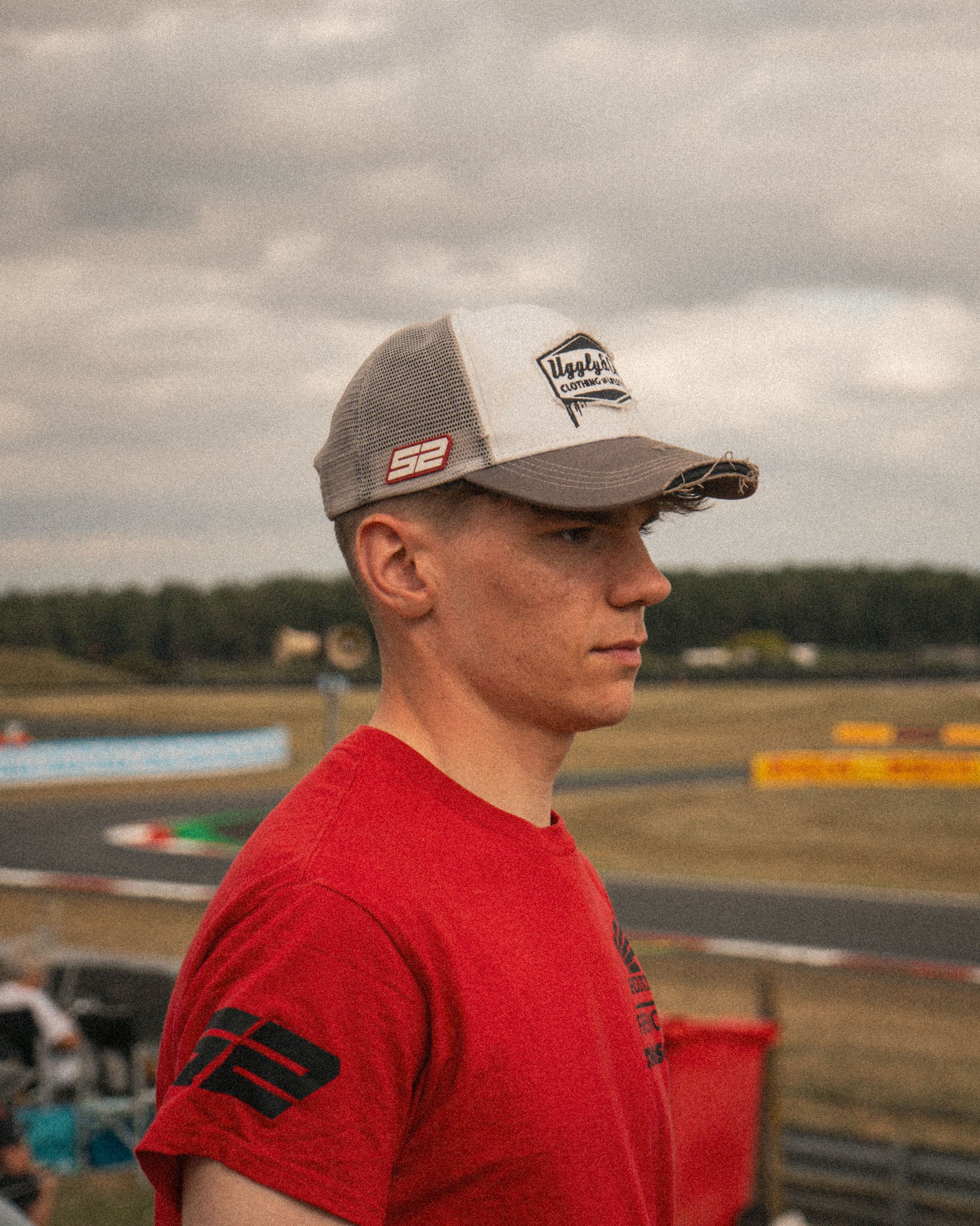 Trackside photo of Kam Dixon wearing the Diamond Trucker Hat in grey and white